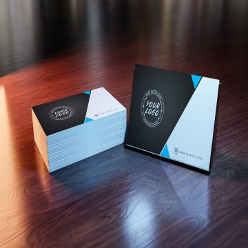 Side view of white business card stack on wooden desk 3D rendering