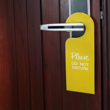 please do not disturb sign hanging at door handle, closed brow d